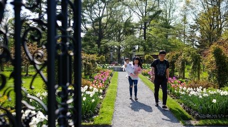 Visitors stroll through the walled garden, home to