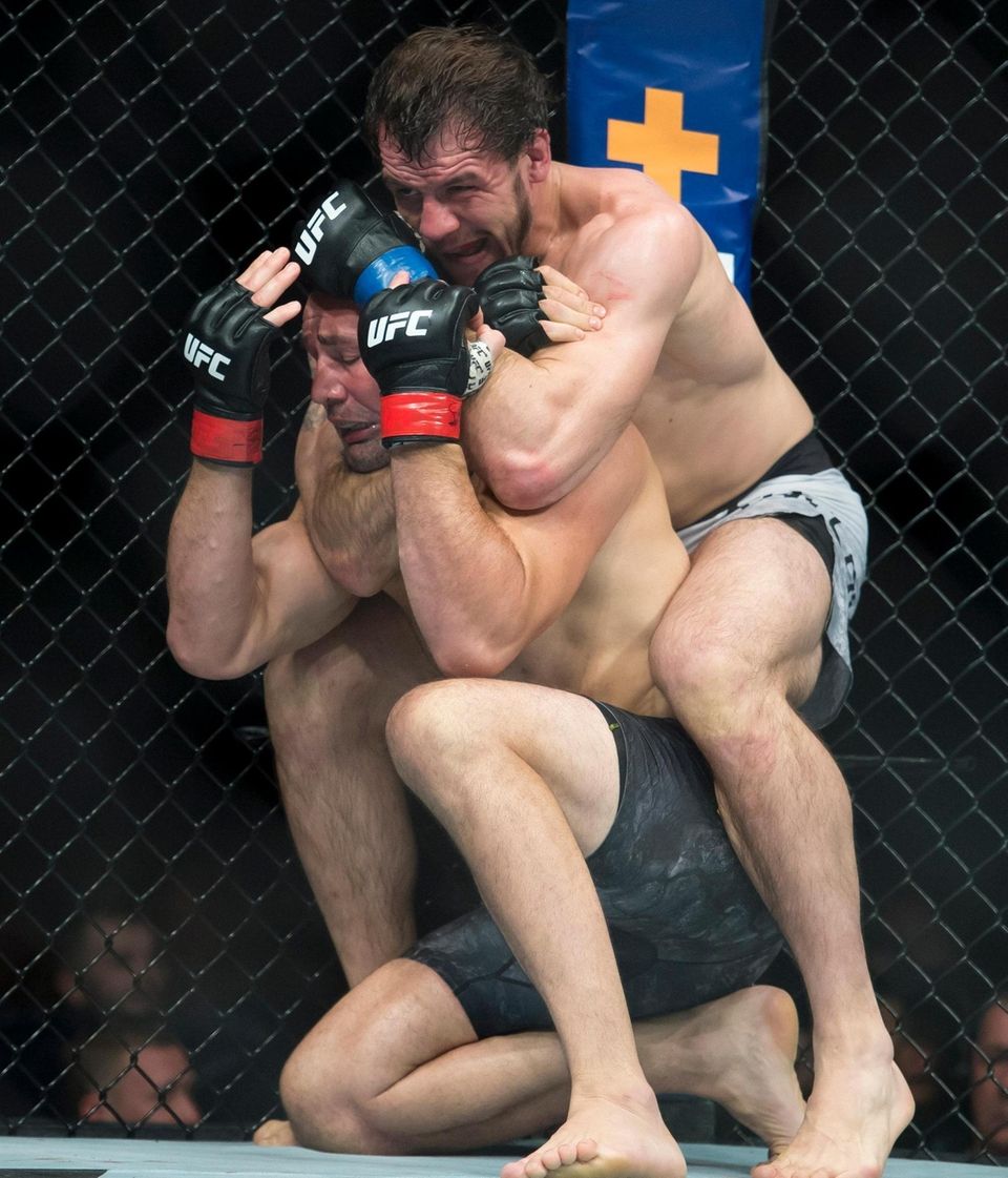 Glover Teixeira, left, fights Nikita Krylov during their