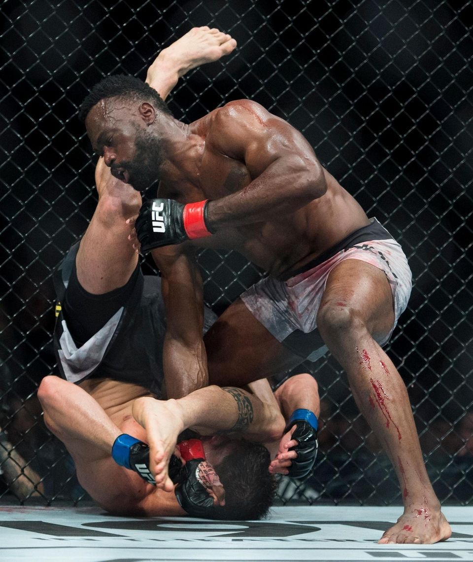 Middleweight fighters Uriah Hall, top, fights Antonio Carlos