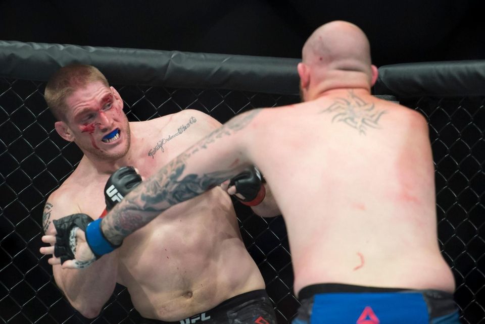 Heavyweight fighters Todd Duffee, left, fights Jeff Hughes