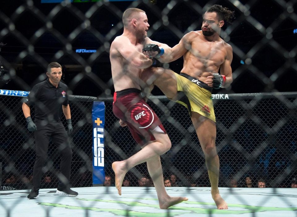 Welterweight fighters Michel Pereira, right, fights Tristan Connelly
