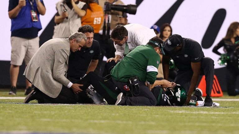 Trevor Siemian of the Jets is attended to