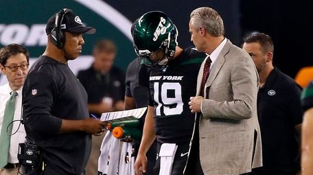 Jets quarterback Trevor Siemian is helped off the