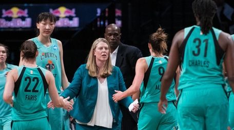 Liberty head coach Katie Smith talks to team