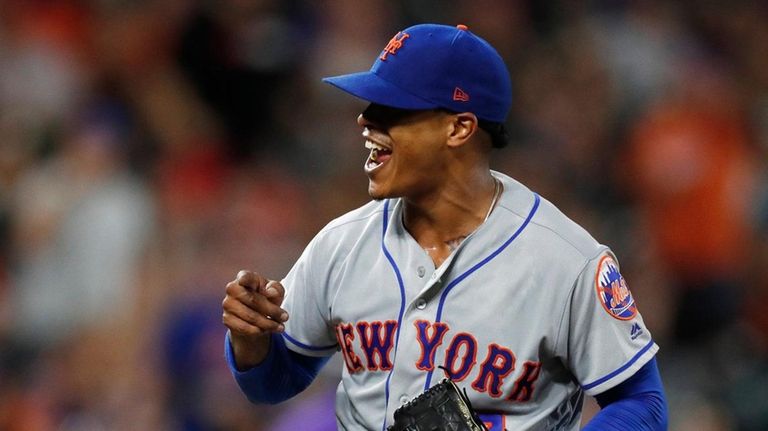 Mets starting pitcher Marcus Stroman reacts after catcher