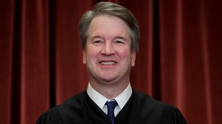 Associate Justice Brett Kavanaugh sits with fellow Supreme