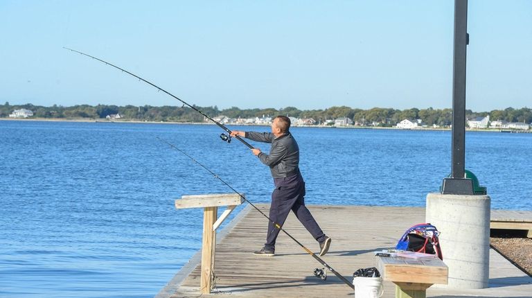 A man casts his line as he fishes