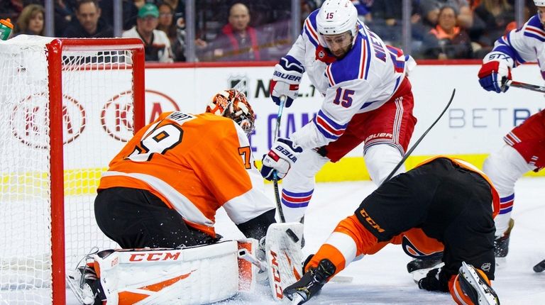 The shot of Rangers' Boo Nieves, center, goes