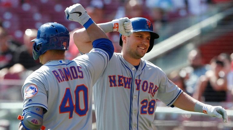 The Mets' J.D. Davis bumps elbows with Wilson