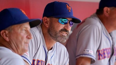 Mets manager Mickey Callaway sits in the dugout