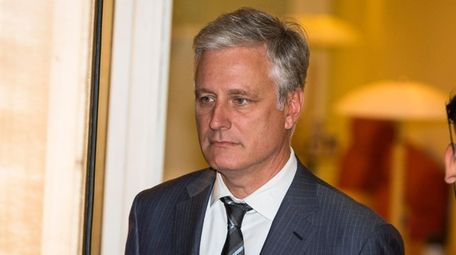 Robert C. OBrien enters the courtroom during the