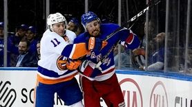 Brendan Smith #42 of the Rangers is checked