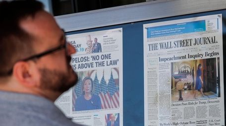 A visitor at the Newseum in Washington looks