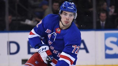Rangers center Filip Chytil skates with the puck