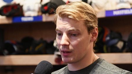 Islanders defenseman Scott Mayfield speaks with the media