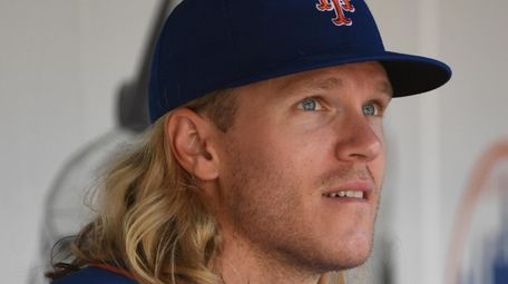 Mets starting pitcher Noah Syndergaard looks on from