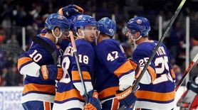 Islander celebrate with New York Islanders defenseman Devon