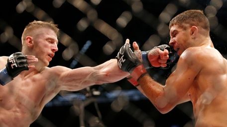 Dan Hooker of New Zealand punches Al Iaquinta