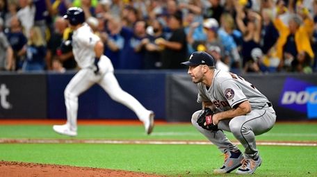 Justin Verlander crouches after allowing a home run