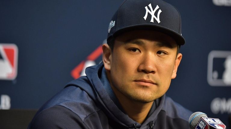 Yankees starting pitcher Masahiro Tanaka (19) speaks to
