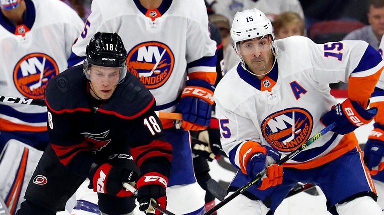 Carolina Hurricanes' Ryan Dzingel (18) battles with Islanders'