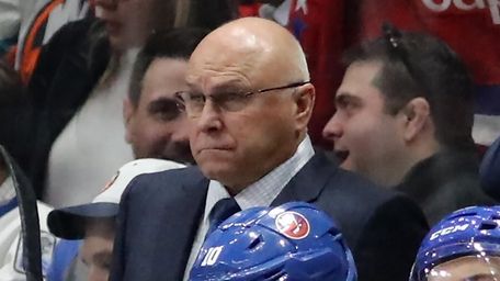 Islanders head coach Barry Trotz watches from the