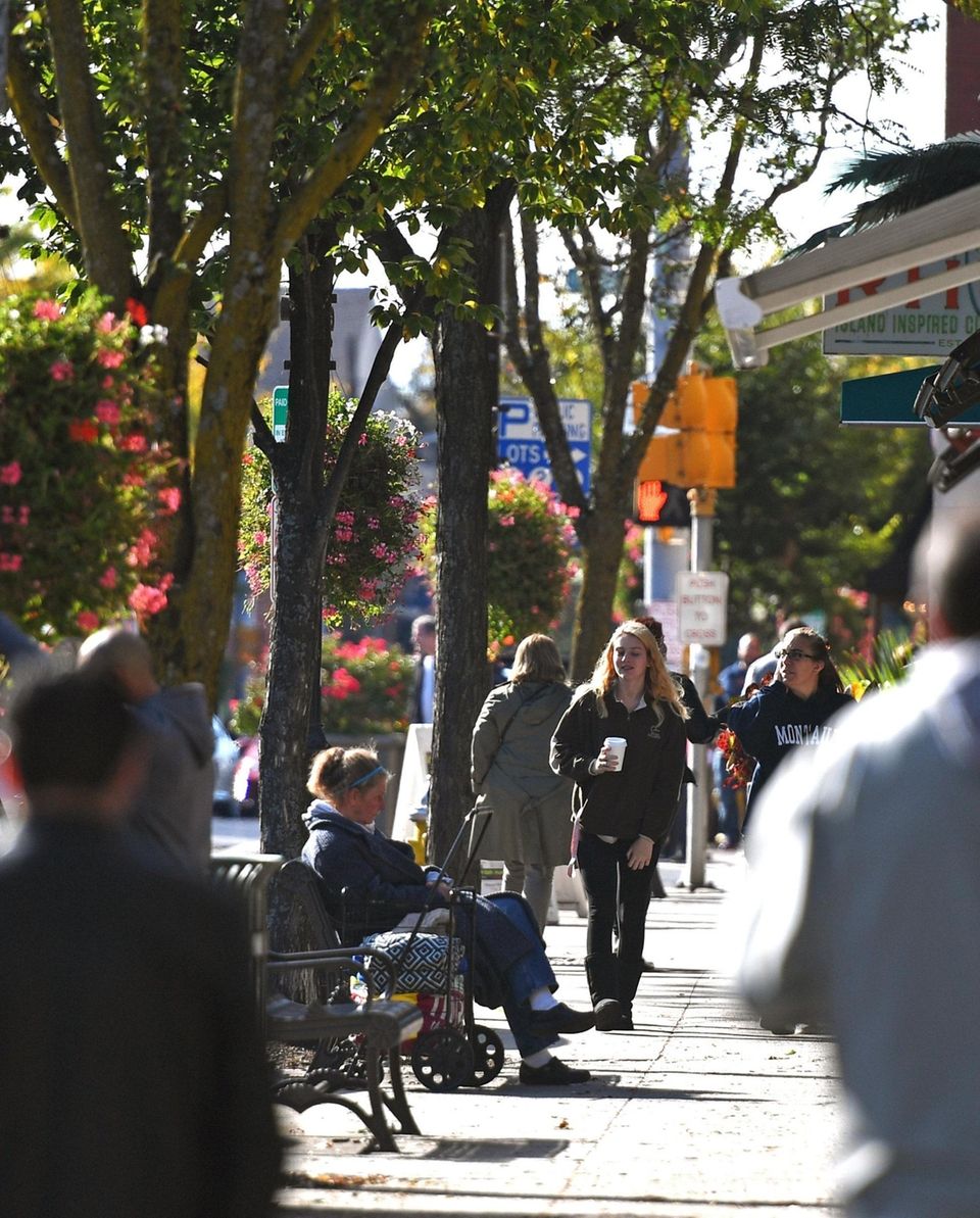 People stroll downtown Patchogue, Saturday, Oct. 12, 2019.