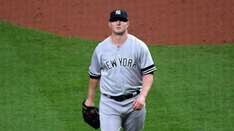 Yankees relief pitcher Zack Britton (53) walks off