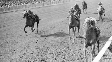 Chateaugay, right, with jockey Braulio Baeza, charges to