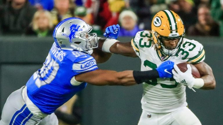 Lions defensive end Trey Flowers reaches to grab