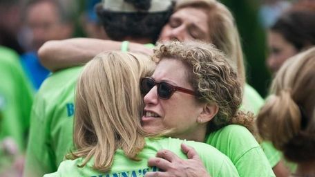Randi Schuller hugs Dawn Titcomb during the walk.