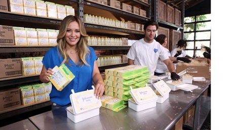 Hilary Duff helps assemble "Care Kits" for Johnson's