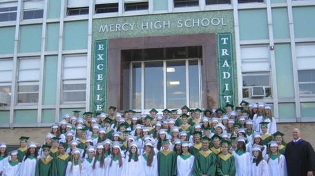 The graduates of McGann-Mercy High School stand in