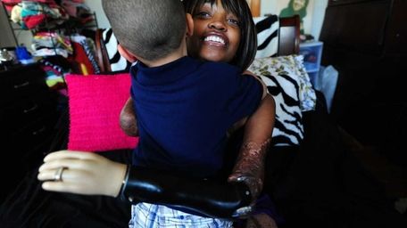 Shannon Smith hugs son Oliver. (June 7, 2012)