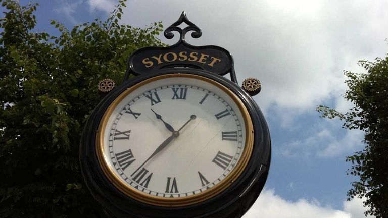 A clock keeps time in downtown Syosset. (May