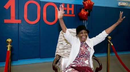 Ida Harris raises her hands for friends and
