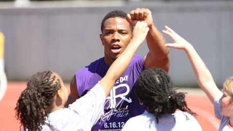 Ray Rice celebrates with participants after finishing jumping