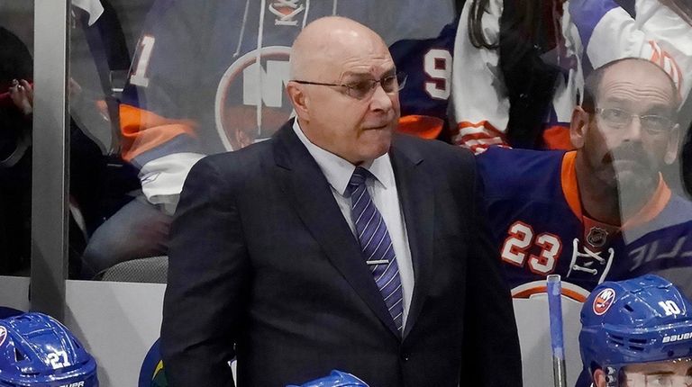 Islanders head coach Barry Trotz watches from the