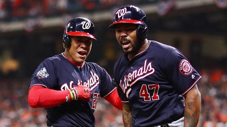 Howie Kendrick of the Nationals is congratulated by