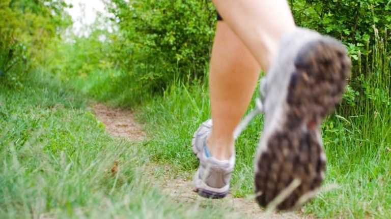 Woman running in forest, cross country fitness, motion