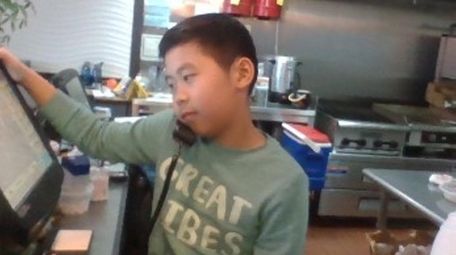 Kidsday reporter Ethan Zheng of Copiague helping at