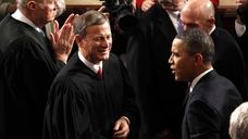 Supreme Court Chief Justice John Roberts greets President