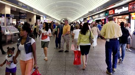 Commuters walk in the tunnel-like main hallway at