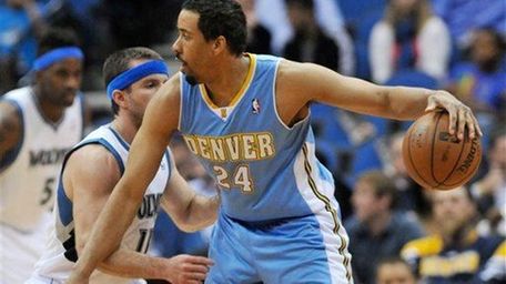 Denver Nuggets' Andre Miller, right, keeps the ball