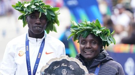 First-place finishers Joyciline Jepkosgei of Kenya and Geoffrey