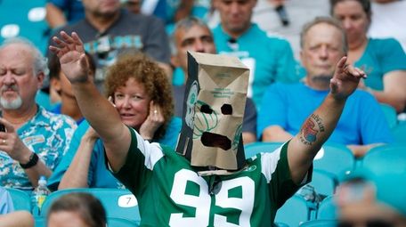 A New York Jets fan wears a paper