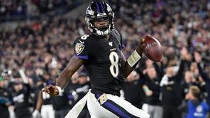 Baltimore Ravens quarterback Lamar Jackson scores on a