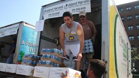 Island Harvest volunteers unloading donated food for distribution