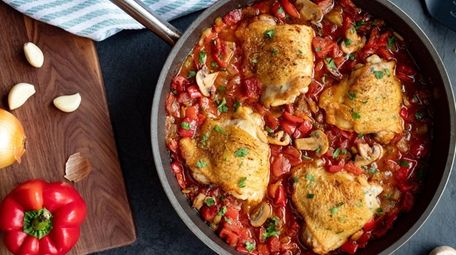 Chicken thighs are simmered with red bell peppers,