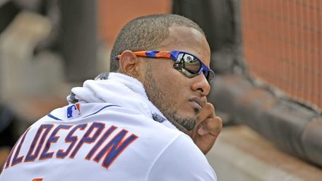 Jordany Valdespin watches the game from the dugout